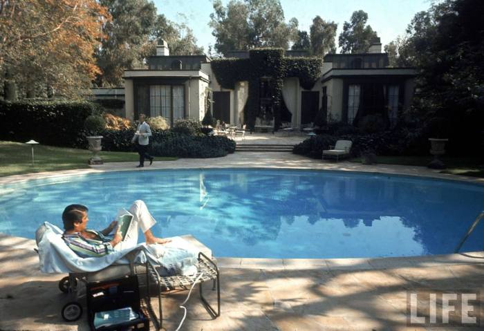 Film director Robert Evans at poolside in backyard of his home-- Beverly Hills, CA 1968.