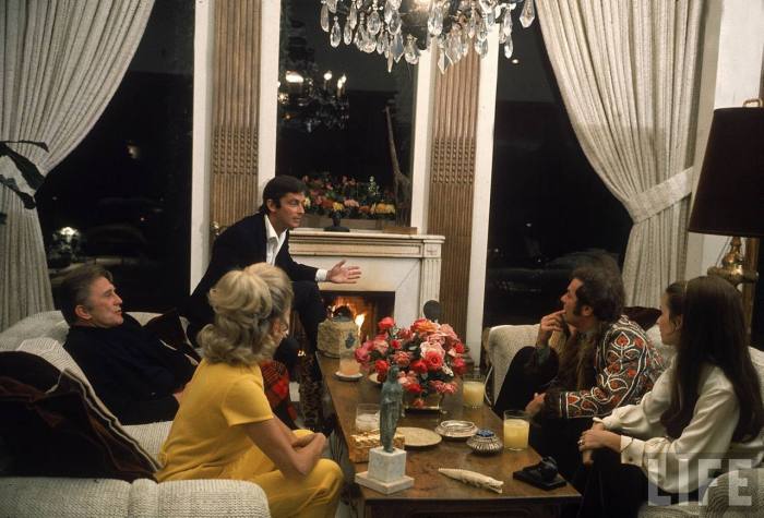 Actor Kirk Douglas, film director Robert Evans, actor Tony Curtis and their wives at Evan's home-- Beverly Hills, CA 1968.
