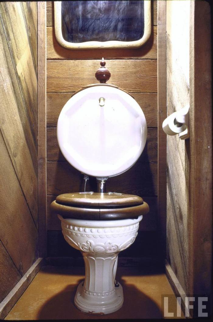 Antique toilet with wooden seat found at a garage sale now in home of art director John Holmes, which is made entirely from used parts.